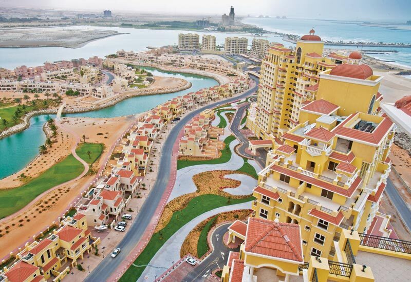 Aerial photograph of Royal Breeze buildings, villas and the lagoon in Al Hamra Village, Ras Al Khaimah